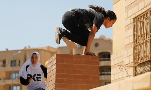 Egyptian women from Parkour Egypt "PKE" practice their parkour skills around buildings on the outskirts of Cairo