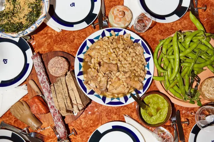 Dinner included a selection of meats, bread from She Wolf bakery, braised rabbit and white beans with a ramp sauce, fava beans and more. CreditPaul Quitoriano